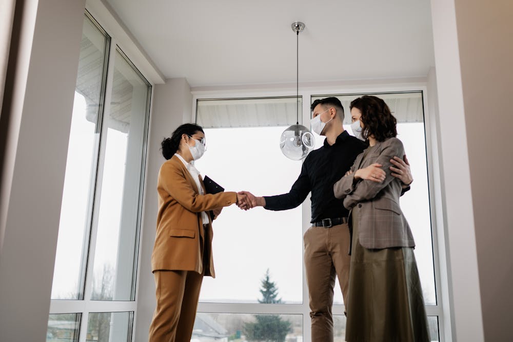 a couple shaking hands with a home auditor