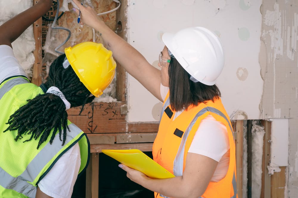 two women inspecting the electrical system